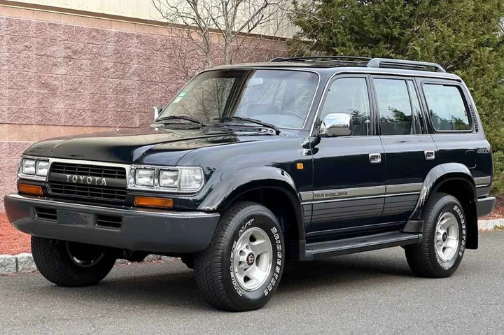 A black 1995 Toyota Land Cruiser parked in left front angle view